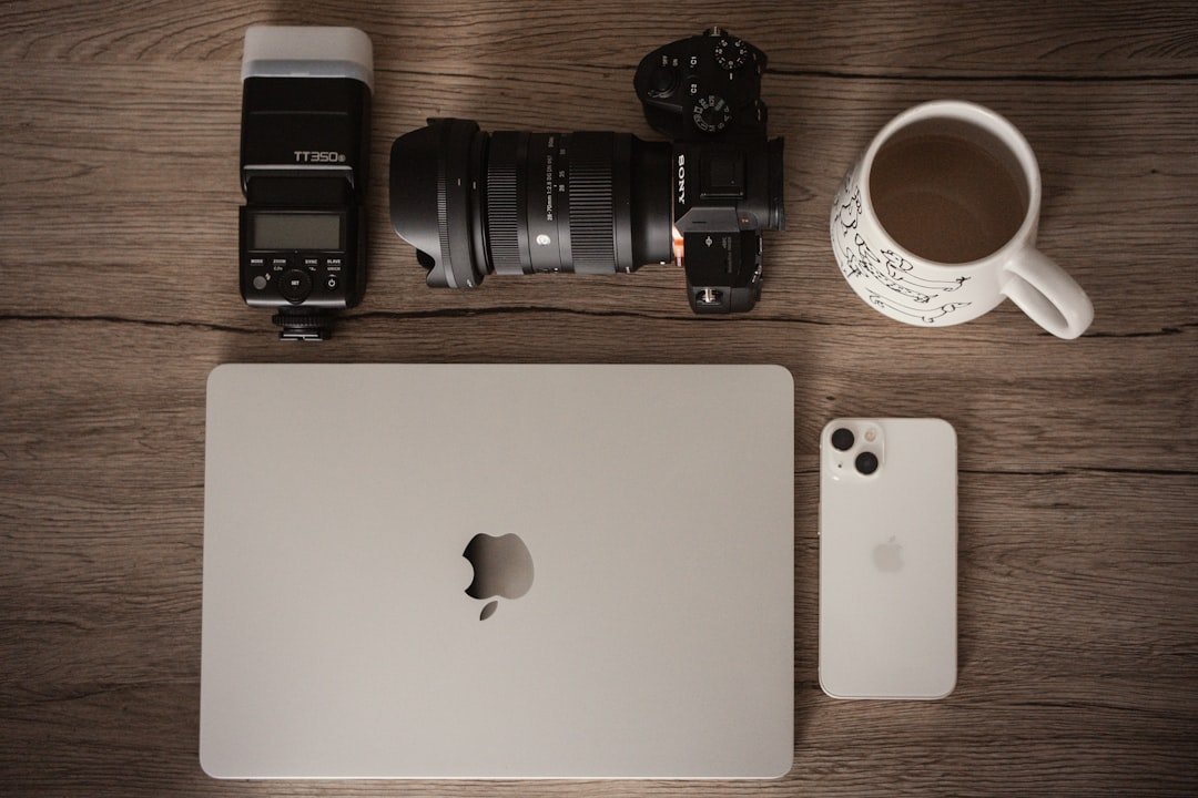 Creative media workspace with camera, laptop, phone and coffee